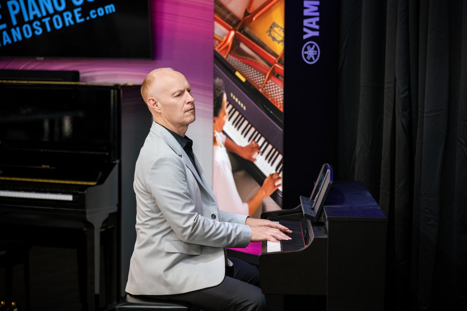 Jon Schmidt playing a Yamaha Clavinova CSP with an iPad running Smart Pianist on the music desk